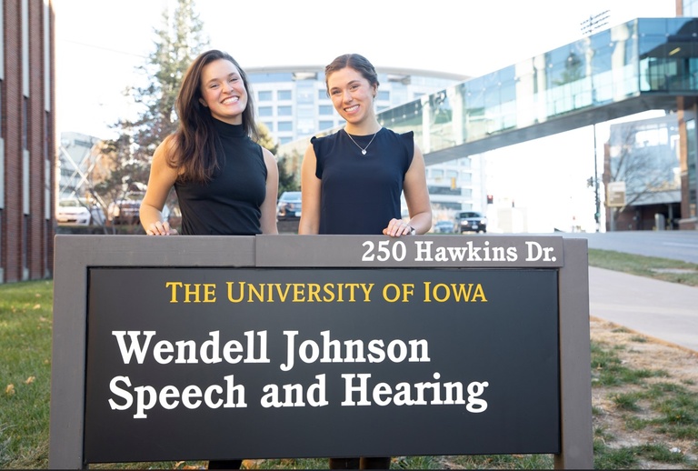 Sarah and Hailey in front of Wendell Johnson sign