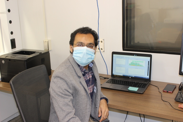 Ishan working at a computer in the lab